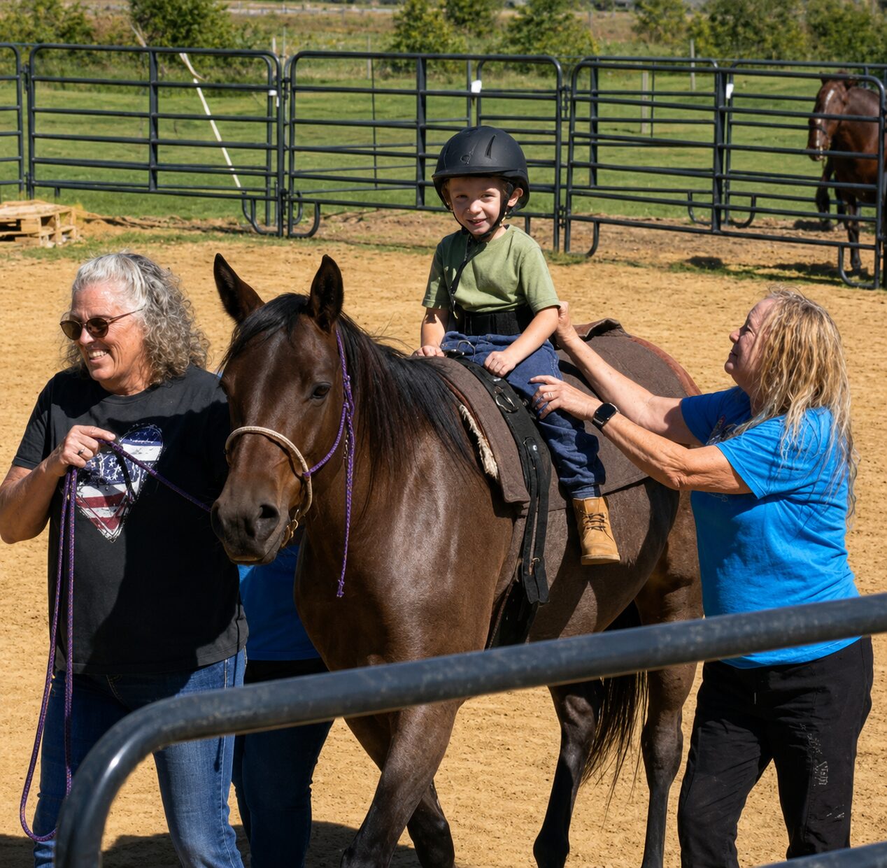 A child wearing a helmet while sitting on a horse, with the help of two therapists